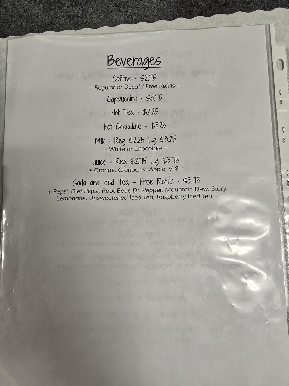 Breakfast menu page with omelets and sandwiches.